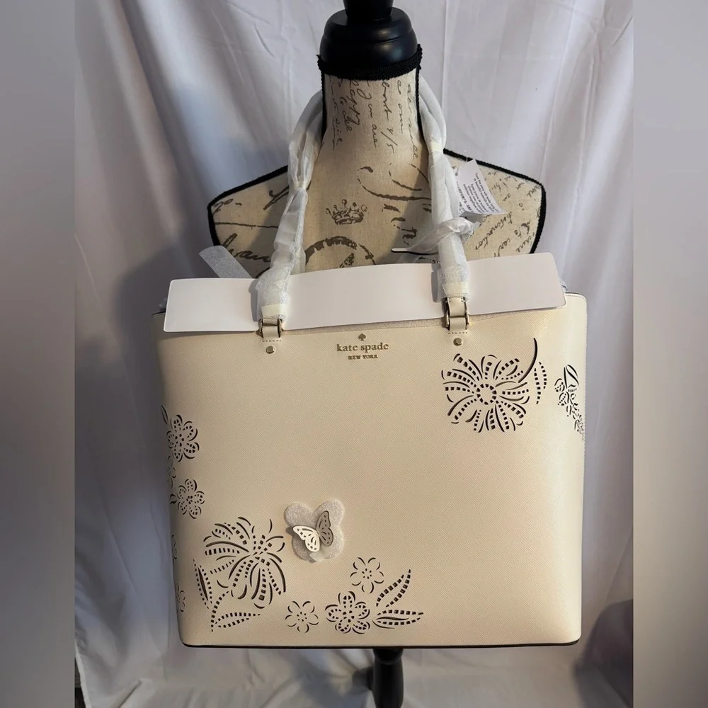 kate spade Cream Tote with Decorative Cutouts and Scarf Accent